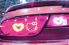 the back end of a purple car with two hearts on it's tail lights