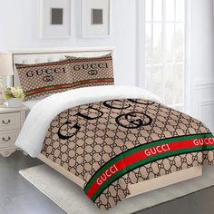 a bed with gucci logo on it in a bedroom next to a dresser and window