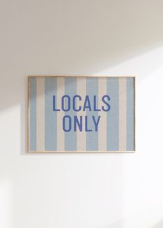 a blue and white striped sign that says locals only hanging on the wall in a room