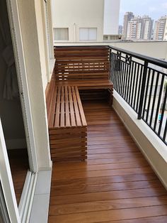 two wooden benches sitting on top of a balcony