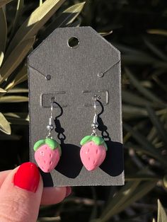 The pink strawberry earrings are made out of polymer clay and glazed in UV resin. I make each one of these with love and care. I hope you love them just as much as I do :) all items are handmade. Each item will vary slightly from the last but this makes each one unique. All items are made to order. This means it'll take me about 1-2 weeks to ship them out. I will try to get them to you as soon as I can! Please note that to ensure quality, each item is glazed in UV resin- however they are still fragile objects so please handle with care🍓💕 Small Pink Earrings For Gifts, Cute Polymer Clay Earrings For Valentine's Day, Pink Heart-shaped Polymer Clay Earrings, Sweet Handmade Polymer Clay Jewelry, Pink Resin Novelty Earrings, Handmade Sweet Polymer Clay Jewelry, Sweet Pink Hypoallergenic Jewelry, Trendy Pink Jewelry With Fruit Design, Sweet Pink Polymer Clay Jewelry