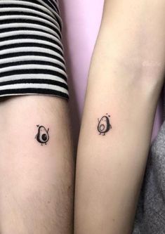 two people with matching tattoos on their legs