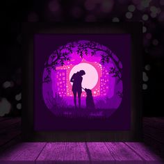 the silhouette of a person and their dog in front of a purple background with lights