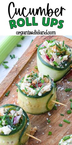 cucumber roll ups on a cutting board with green onions and shredded cheese in the middle