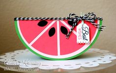 a slice of watermelon with a tag tied to it