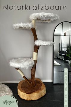 a wooden tree with white feathers on it