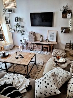 a living room filled with furniture and a flat screen tv mounted to the side of a wall