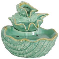 two green bowls with water pouring out of the top, and one is shaped like a flower