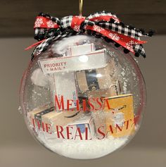 a glass ornament hanging from the ceiling with books on it's side