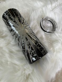 a black and silver case sitting on top of a white fur covered floor