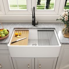 a kitchen sink with a cutting board, knife and fruit on the counter next to it