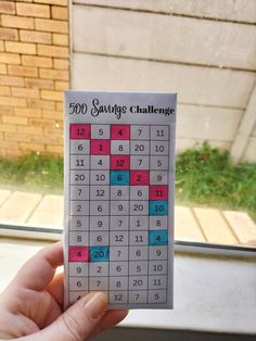 someone is holding up a sud puzzle for the 500 sayings challenge in front of a window