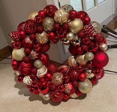 a wreath made out of red and gold ornaments