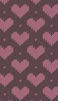 a knitted pattern with hearts in pink and purple colors on a dark background photo