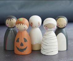 a group of wooden dolls sitting next to each other