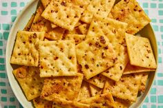 a white plate topped with crackers on top of a table