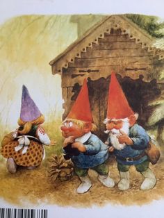 three gnomes are standing in front of a house