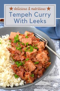 a bowl filled with meat and rice on top of a blue table cloth next to a fork