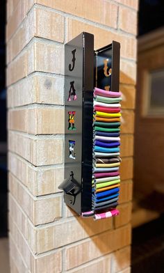 a wall mounted mailbox filled with lots of different colored papers