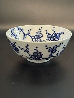 a blue and white bowl sitting on top of a table