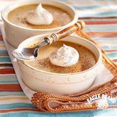 two bowls filled with hot chocolate and whipped cream