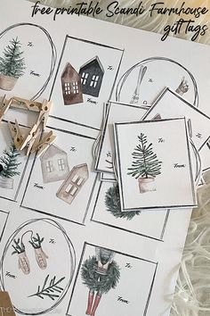 christmas cards and scissors on top of a table with paper cut outs in the shape of houses