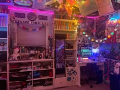 a room filled with lots of colorful lights and decorations on the ceiling, along with bookshelves