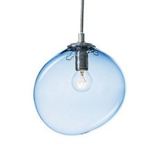 a light that is hanging from a wire on a white wall with a blue glass ball