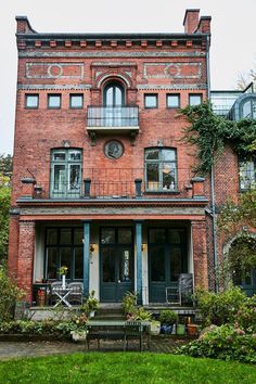 an old brick building with lots of windows and balconies on the second floor