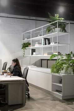 a woman sitting at a desk in an office