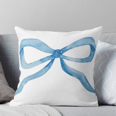 a pillow with a blue bow on it