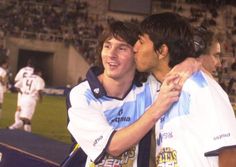 two young men embracing each other at a soccer game