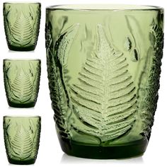 four green glass cups with leaf designs on the front and side, all lined up