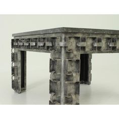 a table made out of metal pipes on a white surface