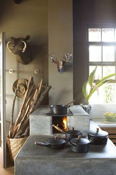 an old fashioned stove with pots and pans on it's burner in a kitchen