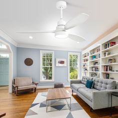 a living room filled with furniture and bookshelves