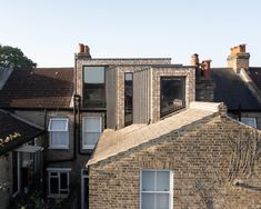 an old brick building with windows on the roof