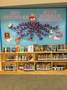 a bulletin board with an octopus on it and bookshelves full of children's books