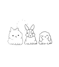 three small rabbits sitting next to each other