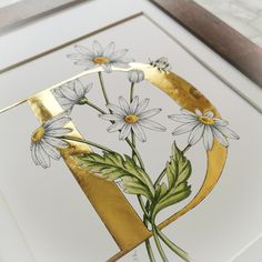 a close up of a painting with flowers in the middle and gold foil on it