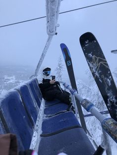 skiers taking pictures from the top of a ski lift in the snow with their skis