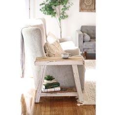 a living room filled with furniture and a coffee table on top of a hard wood floor