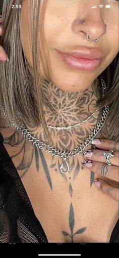 a woman with tattoos and piercings on her chest