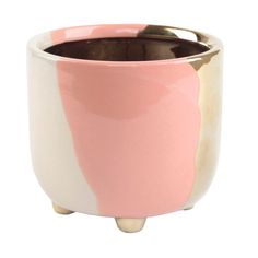 a pink and white cup with gold trim