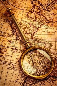 a magnifying glass sitting on top of a map