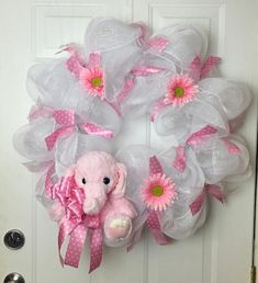 a pink and white wreath with an elephant on it