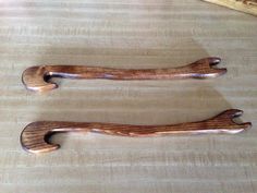 two wooden spoons sitting on top of a table