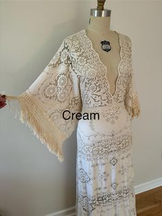 a white dress on a mannequin with the words cream written in black across it