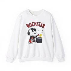 This crewneck sweater features a cute design of Snoopy from the peanuts playing the electric guitar with the word 'Rockstar' above him. perfect for music lovers<3 (For a baggy look, size up 1 to 2 sizes up for the perfect baggy sweater fit) Product Details: .: This sweatshirt feels cozy and is the perfect choice for those colder months. .: Made with a medium-heavy fabric blend.  .: 50% cotton and 50% polyester Snoopy Sweater, Rock Y2k, Baggy Sweater, Baggy Sweaters, Sweater Fits, Vintage Graphic, Music Lover, Vintage Graphics, Playing Guitar