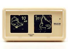 an alarm clock with two cartoon faces on it's face and the time displayed